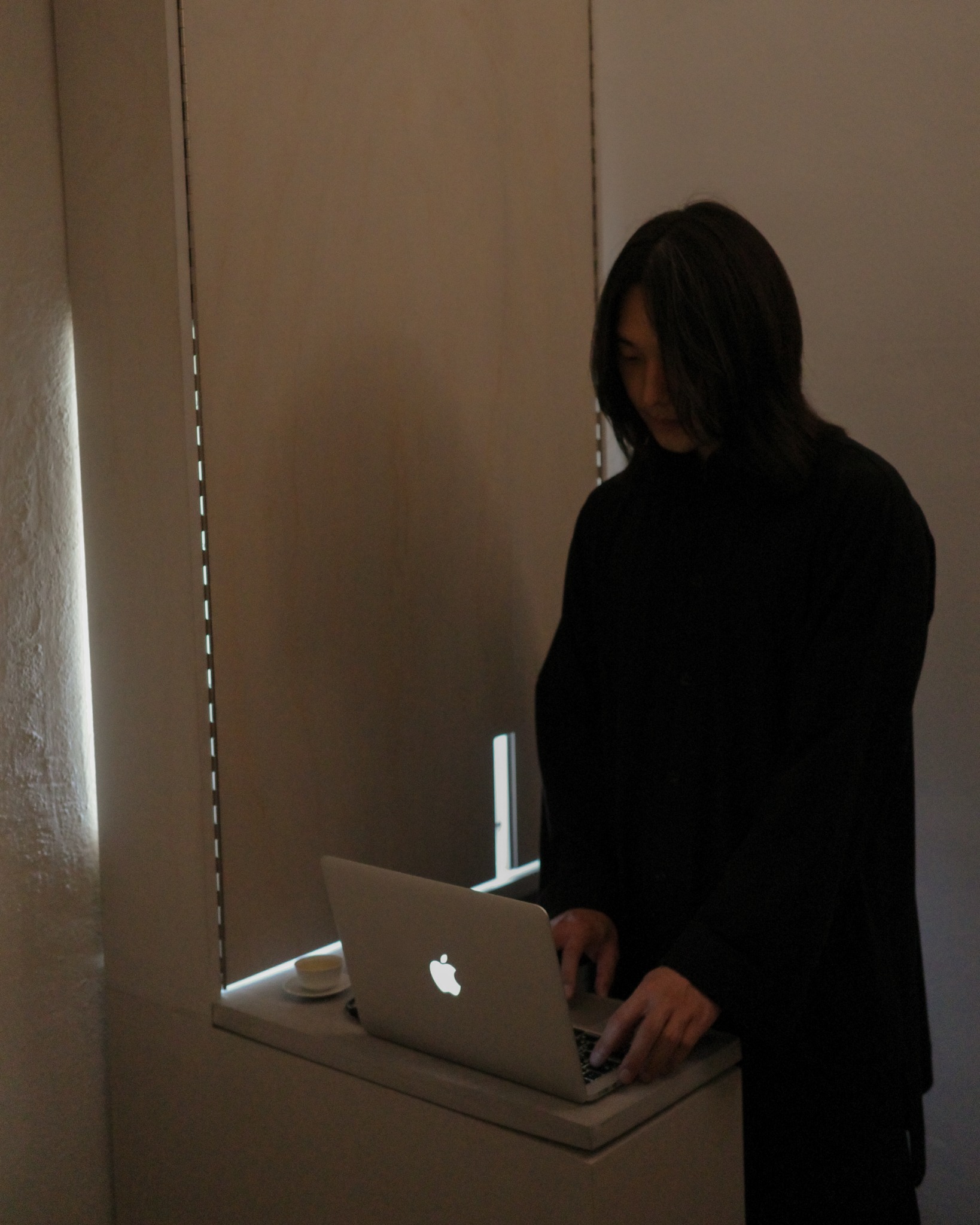 Jinwoo operating a laptop during the exhibition